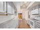 Bright kitchen with wood floors, recessed lighting, light gray cabinets and white appliances at 927 E Charleston Ave, Phoenix, AZ 85022