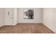 Neutrally decorated living room with wood flooring and a bright window that fills the room with light at 927 E Charleston Ave, Phoenix, AZ 85022