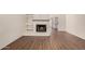 Bright living room with brick fireplace and stylish wood flooring, creating a warm and inviting space at 927 E Charleston Ave, Phoenix, AZ 85022