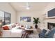 Bright living room with a fireplace, modern decor, a ceiling fan and a comfortable seating area at 927 E Charleston Ave, Phoenix, AZ 85022