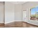 Well-lit living room with hardwood floors, a balcony, and a view of the outdoor scenery at 945 E Playa Del Norte Dr # 3009, Tempe, AZ 85288