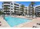 Resort-style pool area with lounge chairs and a cozy fireplace, perfect for relaxation at 945 E Playa Del Norte Dr # 3009, Tempe, AZ 85288