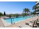 Community pool with lounge chairs and palm trees on a sunny day at 945 E Playa Del Norte Dr # 3009, Tempe, AZ 85288