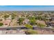 An aerial view showcases a suburban neighborhood, highlighting the home's location, with desert landscaping at 9661 E Glencove Cir, Mesa, AZ 85207