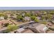 Expansive aerial view of a well-maintained home within a lush, green residential community at 9661 E Glencove Cir, Mesa, AZ 85207