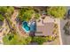 Backyard aerial view features a sparkling pool, patio, and lush greenery at 9661 E Glencove Cir, Mesa, AZ 85207