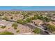 Wide aerial shot showcases a well-landscaped neighborhood with beautiful mountain views in the distance at 9661 E Glencove Cir, Mesa, AZ 85207