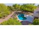 Secluded backyard featuring a sparkling pool, a covered patio, and lush greenery for ultimate privacy at 9661 E Glencove Cir, Mesa, AZ 85207