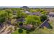 Lush backyard featuring a refreshing pool, vibrant green lawn, and mature trees for enhanced privacy at 9661 E Glencove Cir, Mesa, AZ 85207