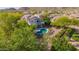 Aerial view of a backyard with a sparkling pool, lush greenery, and beautiful mountain views at 9661 E Glencove Cir, Mesa, AZ 85207