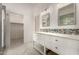 Bathroom featuring double sinks, decorative mirrors and white cabinets at 9661 E Glencove Cir, Mesa, AZ 85207