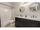 Bathroom features a double sink vanity with an decorative mirror, toilet, and tub-shower combo at 9661 E Glencove Cir, Mesa, AZ 85207
