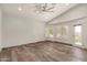Bright bedroom with wood floors, ceiling fan, and multiple windows at 9661 E Glencove Cir, Mesa, AZ 85207