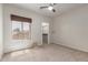 Neutral bedroom with a large window and a walk-in closet with shelving at 9661 E Glencove Cir, Mesa, AZ 85207