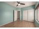 Bedroom with wood flooring, a ceiling fan, and sliding closet doors at 9661 E Glencove Cir, Mesa, AZ 85207