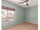 Bedroom with wood flooring and a window looking out to the front of the property at 9661 E Glencove Cir, Mesa, AZ 85207