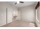 Spacious bedroom with carpet flooring and an adjoining room through a doorway at 9661 E Glencove Cir, Mesa, AZ 85207
