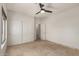Bedroom with travertine flooring, a ceiling fan, and a closet with sliding doors at 9661 E Glencove Cir, Mesa, AZ 85207