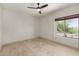 Bright, empty bedroom with neutral walls and a window at 9661 E Glencove Cir, Mesa, AZ 85207