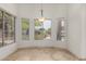 Cozy dining area with garden views from surrounding windows, complemented by tiled flooring and a stylish light fixture at 9661 E Glencove Cir, Mesa, AZ 85207
