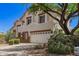 Charming two-story home featuring mature trees, desert landscaping, and a three-car garage at 9661 E Glencove Cir, Mesa, AZ 85207