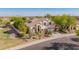 Inviting two-story home showcasing mature landscaping, a tile roof, and a well manicured yard at 9661 E Glencove Cir, Mesa, AZ 85207