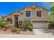 Two-story home boasts desert landscaping, a neutral color palette, and a three-car garage at 9661 E Glencove Cir, Mesa, AZ 85207