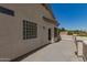 Exterior view of a house with stucco walls and a sunny patio area at 9661 E Glencove Cir, Mesa, AZ 85207
