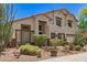 Two-story home boasts desert landscaping, a neutral color palette, and a three-car garage at 9661 E Glencove Cir, Mesa, AZ 85207
