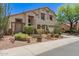 Two-story home boasts desert landscaping, a neutral color palette, and a three-car garage at 9661 E Glencove Cir, Mesa, AZ 85207