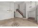 Spacious foyer with decorative tile flooring, staircase, and contemporary lighting fixtures, leading to multiple rooms at 9661 E Glencove Cir, Mesa, AZ 85207