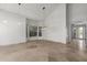 Bright living room with high ceilings, travertine floors, a statement chandelier, and neutral paint at 9661 E Glencove Cir, Mesa, AZ 85207