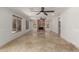 Open-concept living room with tile flooring, a stone fireplace, and large windows providing ample natural light at 9661 E Glencove Cir, Mesa, AZ 85207