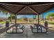 Community picnic area with picnic tables, trash bins and views of playground at 9661 E Glencove Cir, Mesa, AZ 85207