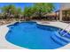 The backyard boasts a pristine pool, lush landscaping, and mature trees, perfect for outdoor relaxation and entertainment at 9661 E Glencove Cir, Mesa, AZ 85207