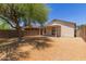 A gravel backyard features a covered patio, enclosed by block wall fencing for privacy at 9717 W Purdue Ave, Peoria, AZ 85345