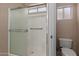 Bathroom shower featuring glass enclosure and window at 9717 W Purdue Ave, Peoria, AZ 85345