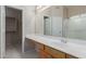 Bathroom with a walk-in shower, large mirror, and wood vanity at 9717 W Purdue Ave, Peoria, AZ 85345