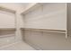 Walk-in closet with wood railing and neutral colored walls at 9717 W Purdue Ave, Peoria, AZ 85345