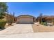 Charming single-story home featuring a two-car garage, desert landscaping, and a welcoming facade under a clear blue sky at 9717 W Purdue Ave, Peoria, AZ 85345