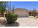 Charming single-story home featuring a two-car garage, desert landscaping, and a well-maintained lawn at 9717 W Purdue Ave, Peoria, AZ 85345