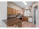 Cozy kitchen features ample wood cabinetry, tile flooring, and modern appliances at 9717 W Purdue Ave, Peoria, AZ 85345