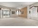 Spacious living room featuring neutral carpet, a ceiling fan, and multiple windows at 9717 W Purdue Ave, Peoria, AZ 85345