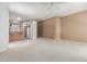 Open-concept living area flows into the kitchen, featuring neutral carpet, and a well-lit window at 9717 W Purdue Ave, Peoria, AZ 85345