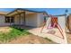 Backyard with covered patio and swing set, perfect for outdoor entertaining and relaxation at 9801 N 56Th Dr, Glendale, AZ 85302