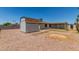 Large backyard features rock ground cover, a shed for extra storage, and a swing set for  at 9801 N 56Th Dr, Glendale, AZ 85302