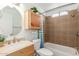 This clean bathroom includes a vanity, toilet, tub, and shower with tile surround at 9801 N 56Th Dr, Glendale, AZ 85302