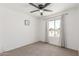 This bedroom features neutral carpeting and a ceiling fan for optimal comfort at 9801 N 56Th Dr, Glendale, AZ 85302