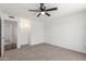 A simple bedroom with neutral carpet and a ceiling fan at 9801 N 56Th Dr, Glendale, AZ 85302