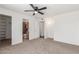 Bedroom boasts neutral carpet with access to an ensuite bathroom and walk-in closet at 9801 N 56Th Dr, Glendale, AZ 85302
